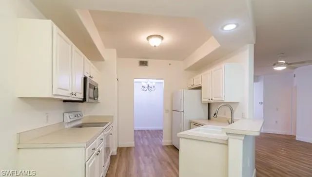 a kitchen with a sink a stove and a refrigerator