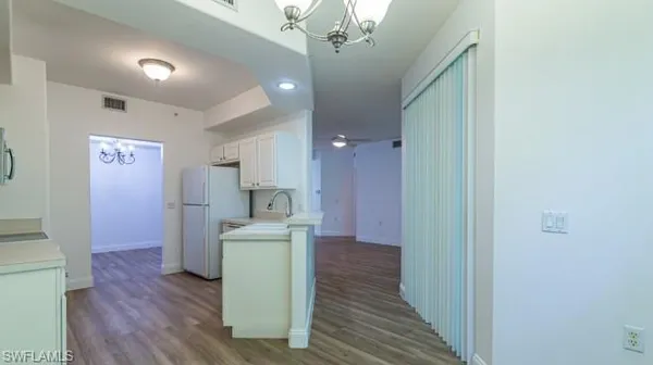 a view of a kitchen from the hallway