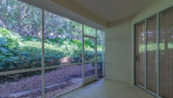 a view of a room with trees in the background