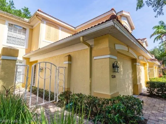 a front view of a house with plants