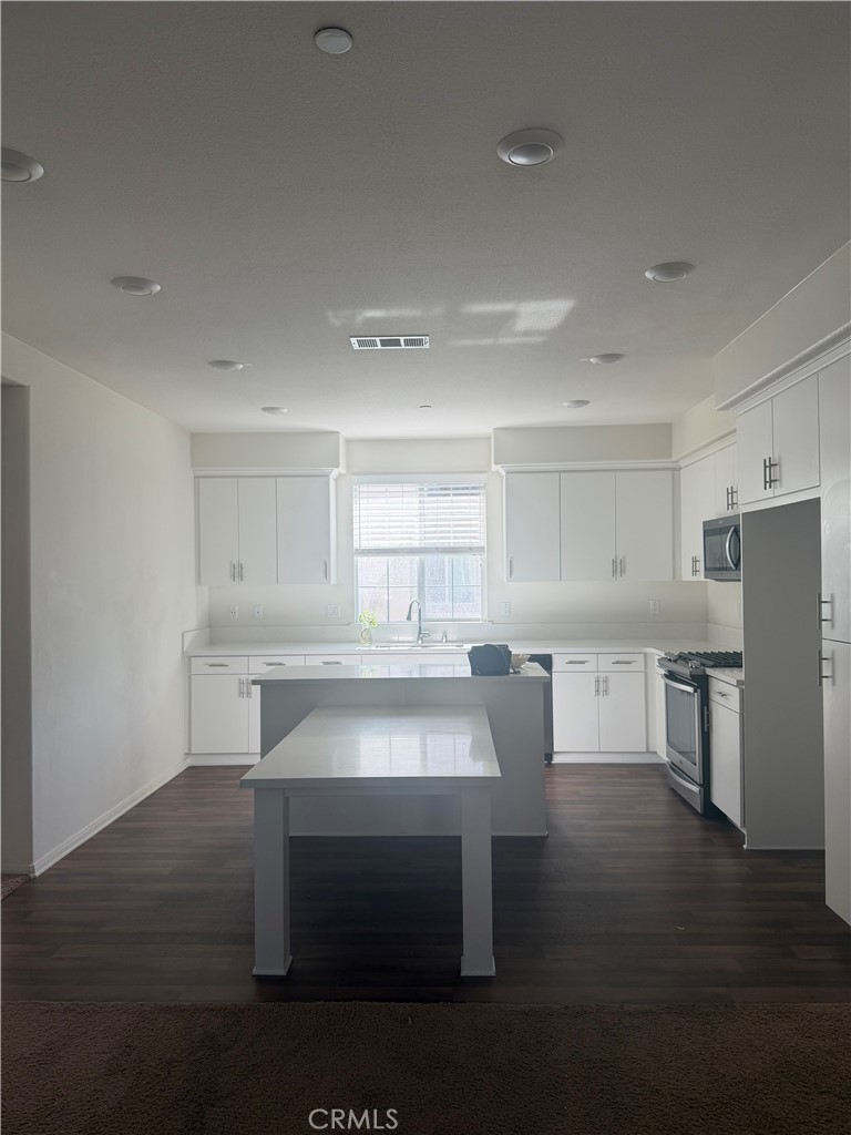 7357 Solstice Place Rancho Cucamonga, CA 91739 - Photo 5 of 12 a room with a table chairs microwave and view kitchen