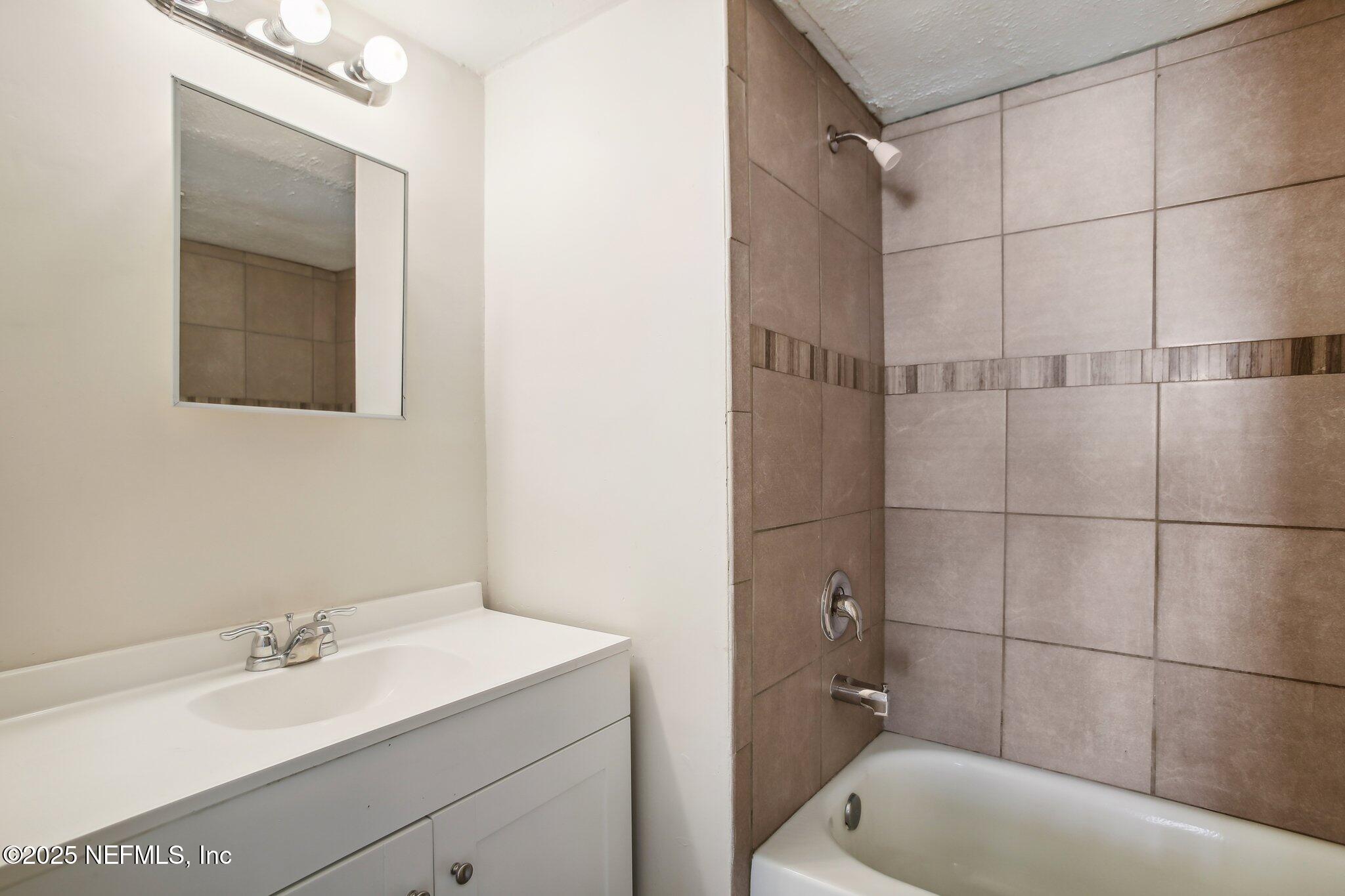851 Bert Road, Unit 11 Jacksonville, FL 32211 - Photo 16 of 24 a bathroom with a sink and a bathtub