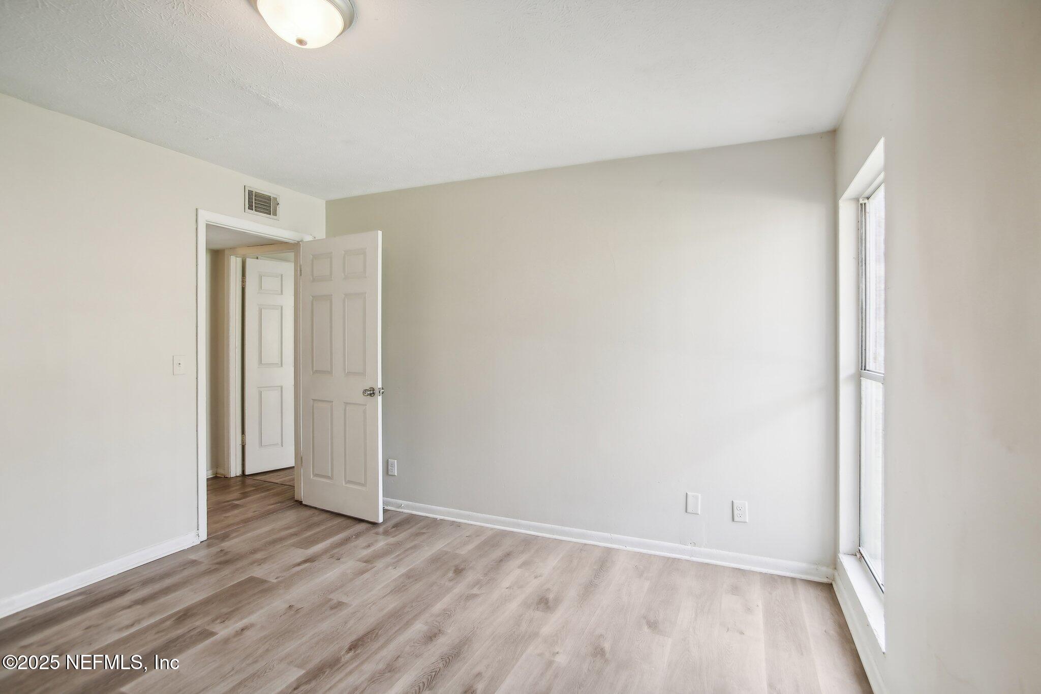 851 Bert Road, Unit 11 Jacksonville, FL 32211 - Photo 17 of 24 a view of an empty room and wooden floor