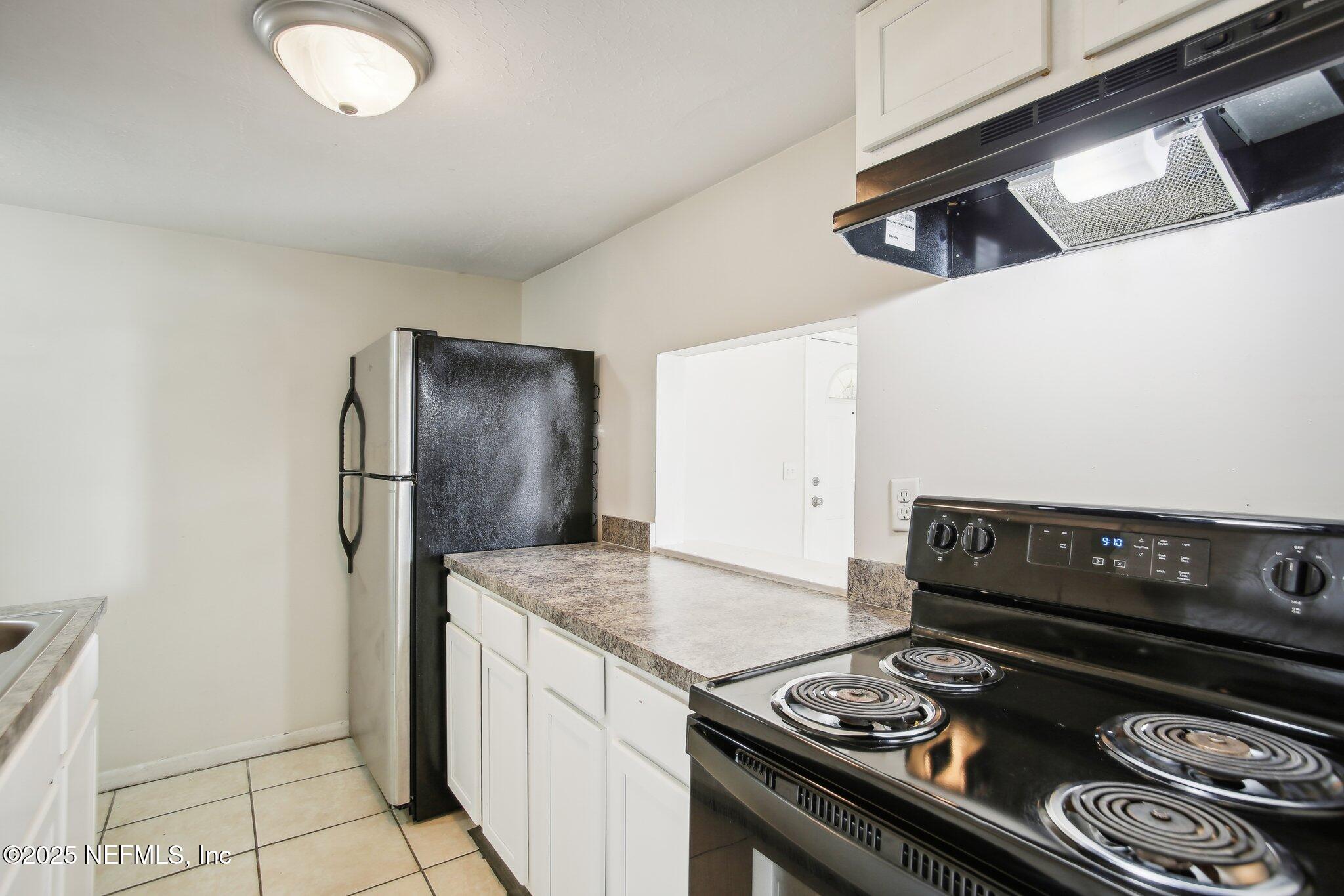 851 Bert Road, Unit 11 Jacksonville, FL 32211 - Photo 2 of 24 a kitchen with a stove and a refrigerator