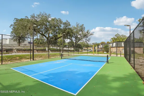 a view of an outdoor space and basketball court