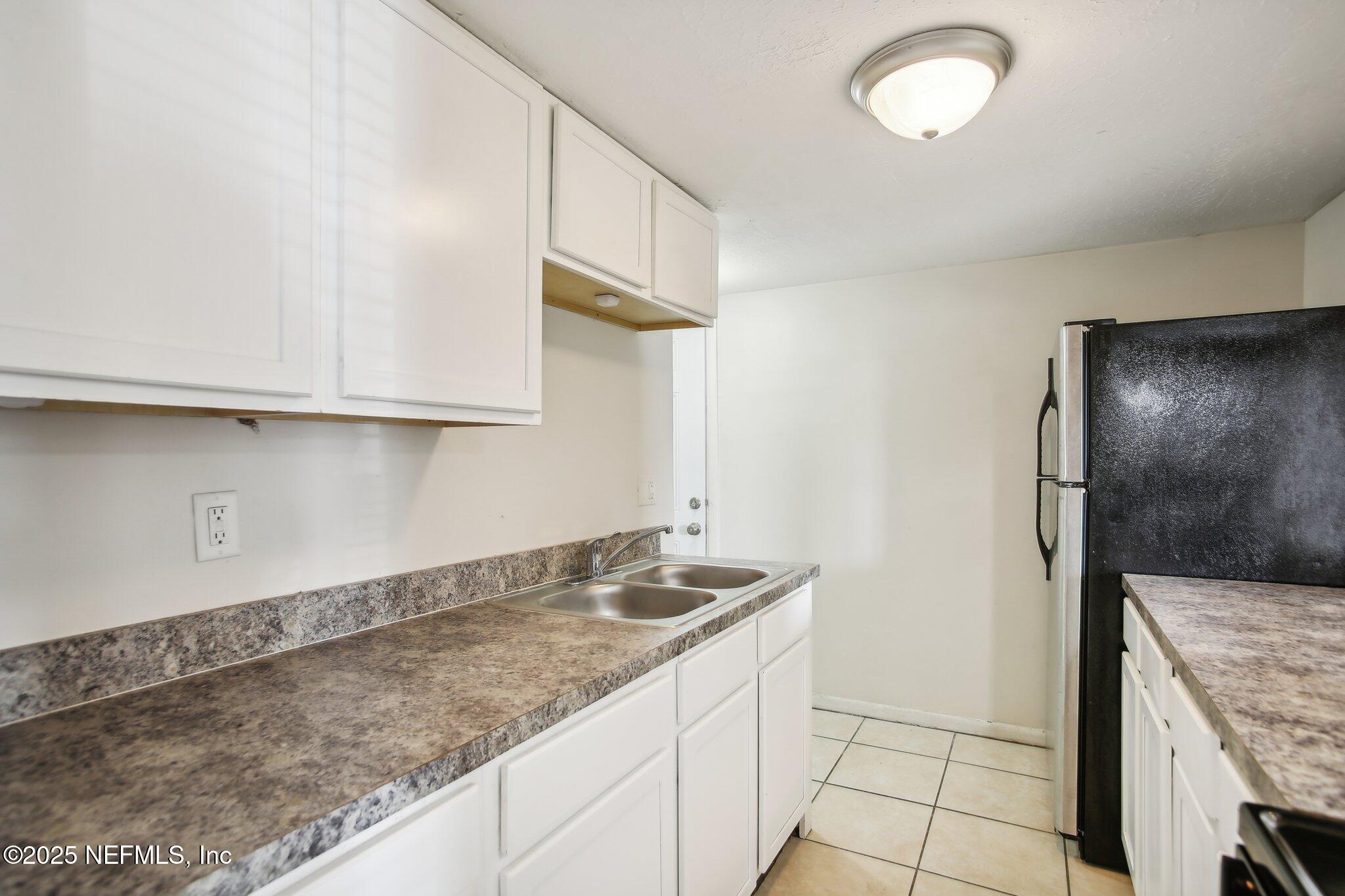 851 Bert Road, Unit 11 Jacksonville, FL 32211 - Photo 5 of 24 a kitchen with granite countertop a sink and a stove