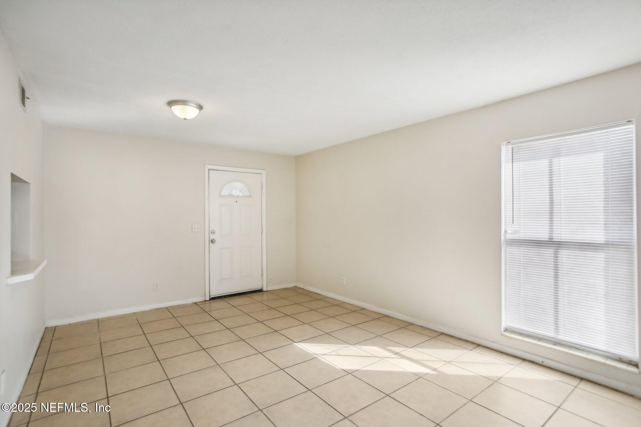 851 Bert Road, Unit 11 Jacksonville, FL 32211 - Photo 8 of 24 a view of an empty room and window