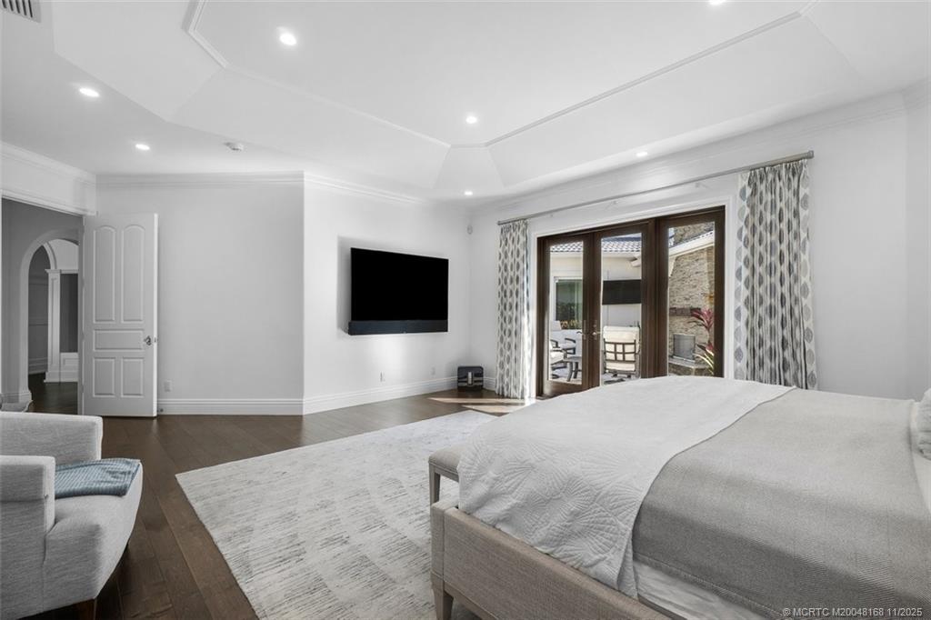 1904 Southeast Sailfish Point Boulevard Stuart, FL 34996 - Photo 22 of 64 a bedroom with a large bed and a flat screen tv
