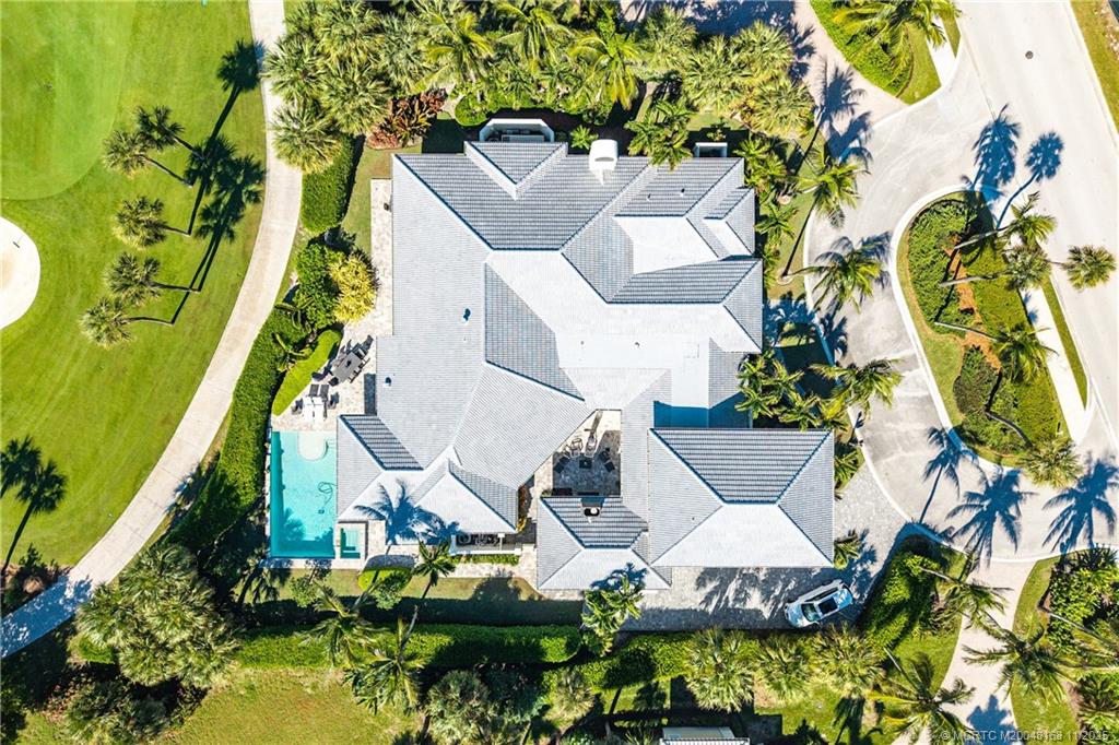 1904 Southeast Sailfish Point Boulevard Stuart, FL 34996 - Photo 56 of 64 an aerial view of a house with swimming pool and garden