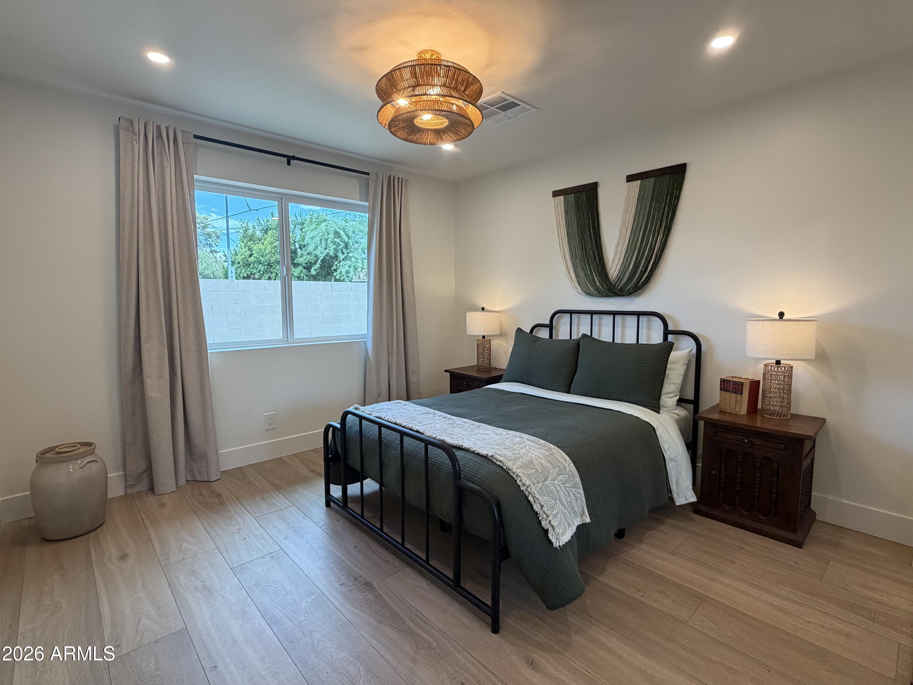 3341 East Cochise Road Phoenix, AZ 85028 - Photo 35 of 46 a bedroom with a bed lamp and a large window
