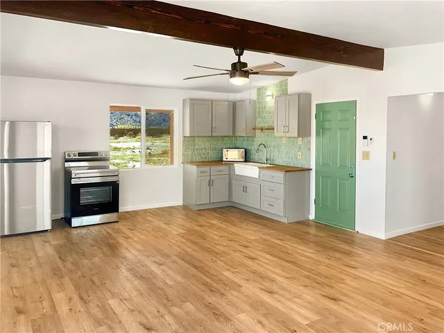a kitchen with stainless steel appliances granite countertop a refrigerator and a stove top oven