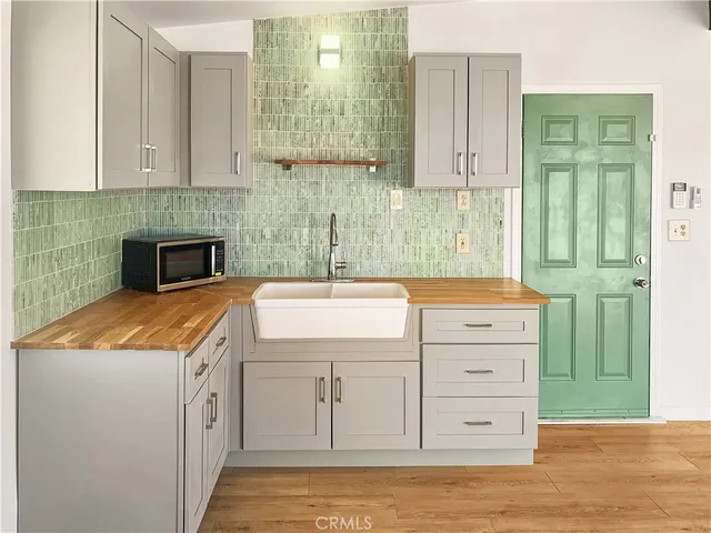 a kitchen with cabinets appliances and a counter space