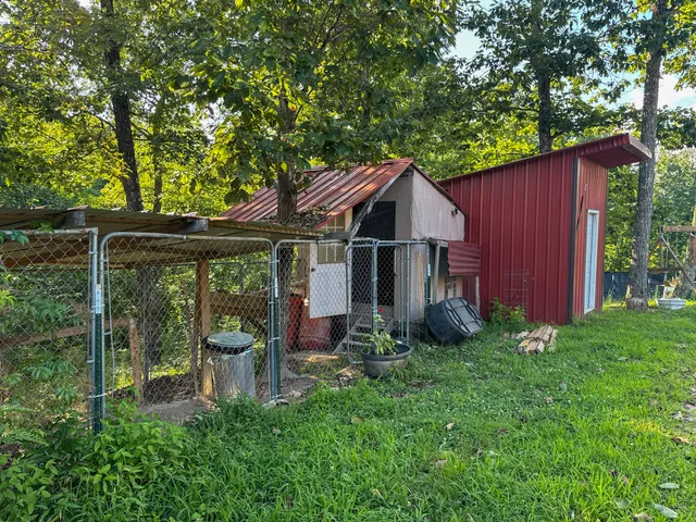 a view of a chairs and table in the back yard of the house