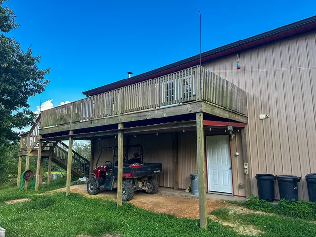 a backyard of a house with yard barbeque oven and outdoor seating