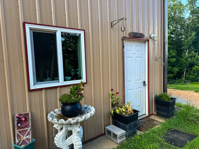 a backyard of a house with lots of green space and fountain