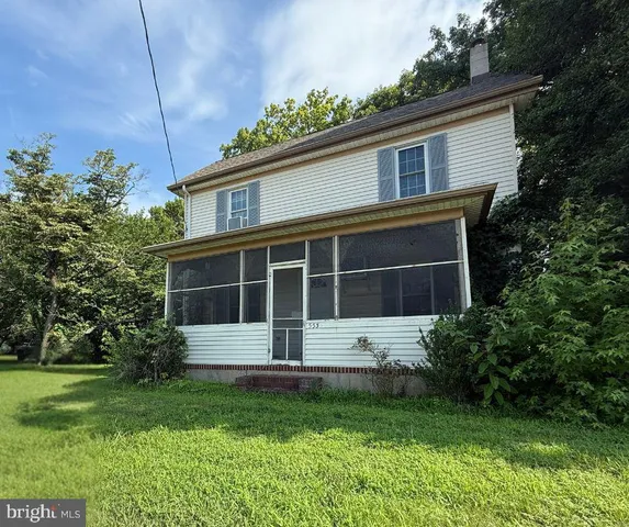 a view of house with yard