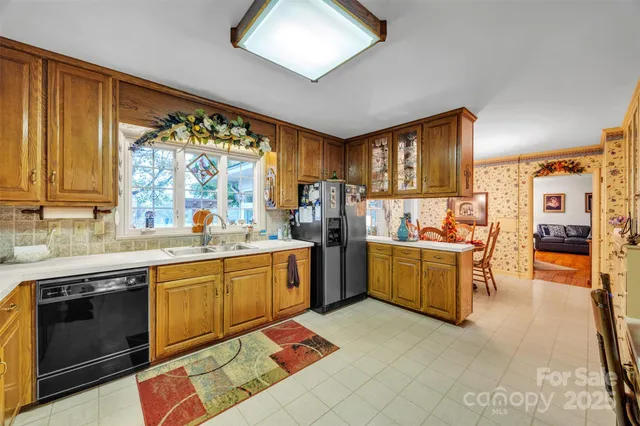 a kitchen with a sink cabinets and window