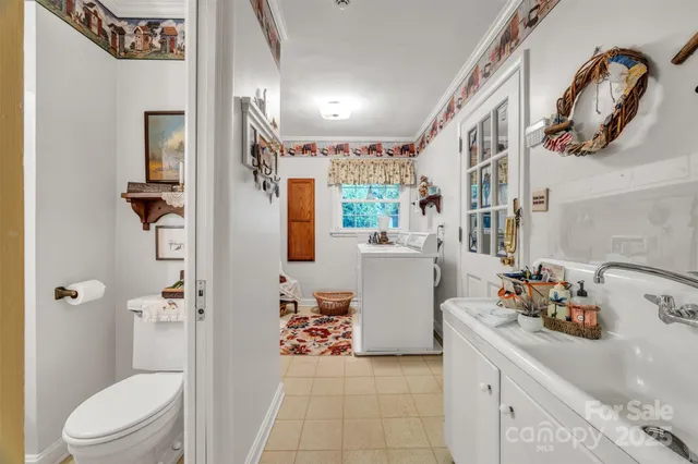 a bathroom with a sink a toilet and shower curtain
