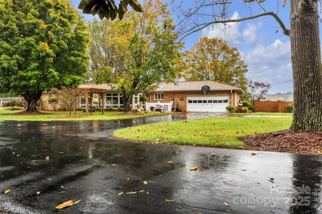 a view of swimming pool with outdoor seating and covered with trees