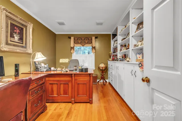 a kitchen with stainless steel appliances granite countertop a lot of cabinets and wooden floor