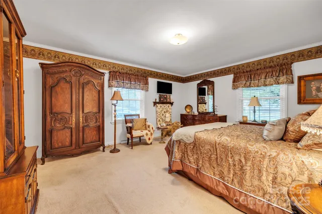 a bedroom with bed and a large window