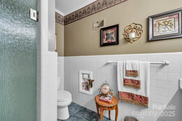 a living room with furniture and a toilet