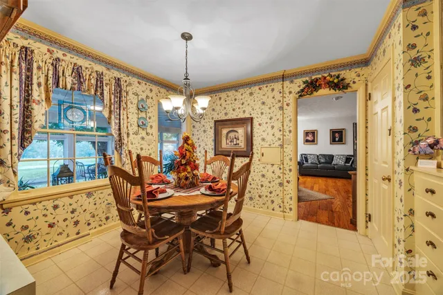 a view of a dining room with furniture and chandelier