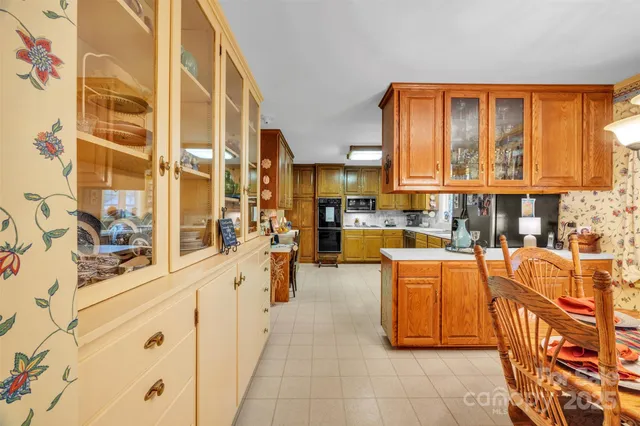 a large white kitchen with stainless steel appliances