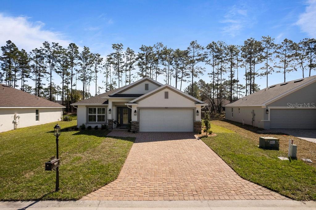 7697 Southwest 180th Circle Dunnellon, FL 34432 - Photo 1 of 45 a front view of a house with garden