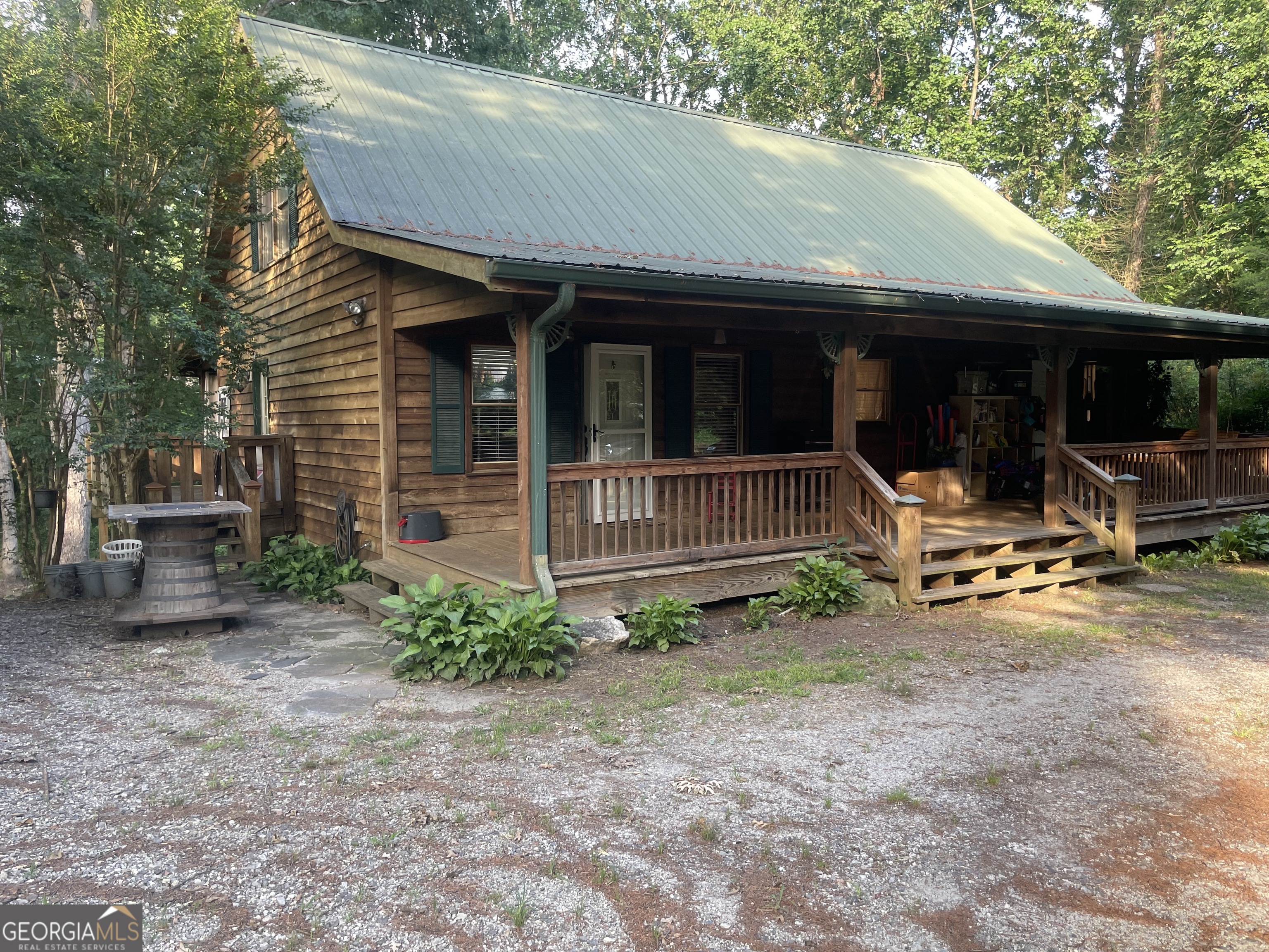 a front view of a house with porch and furniture