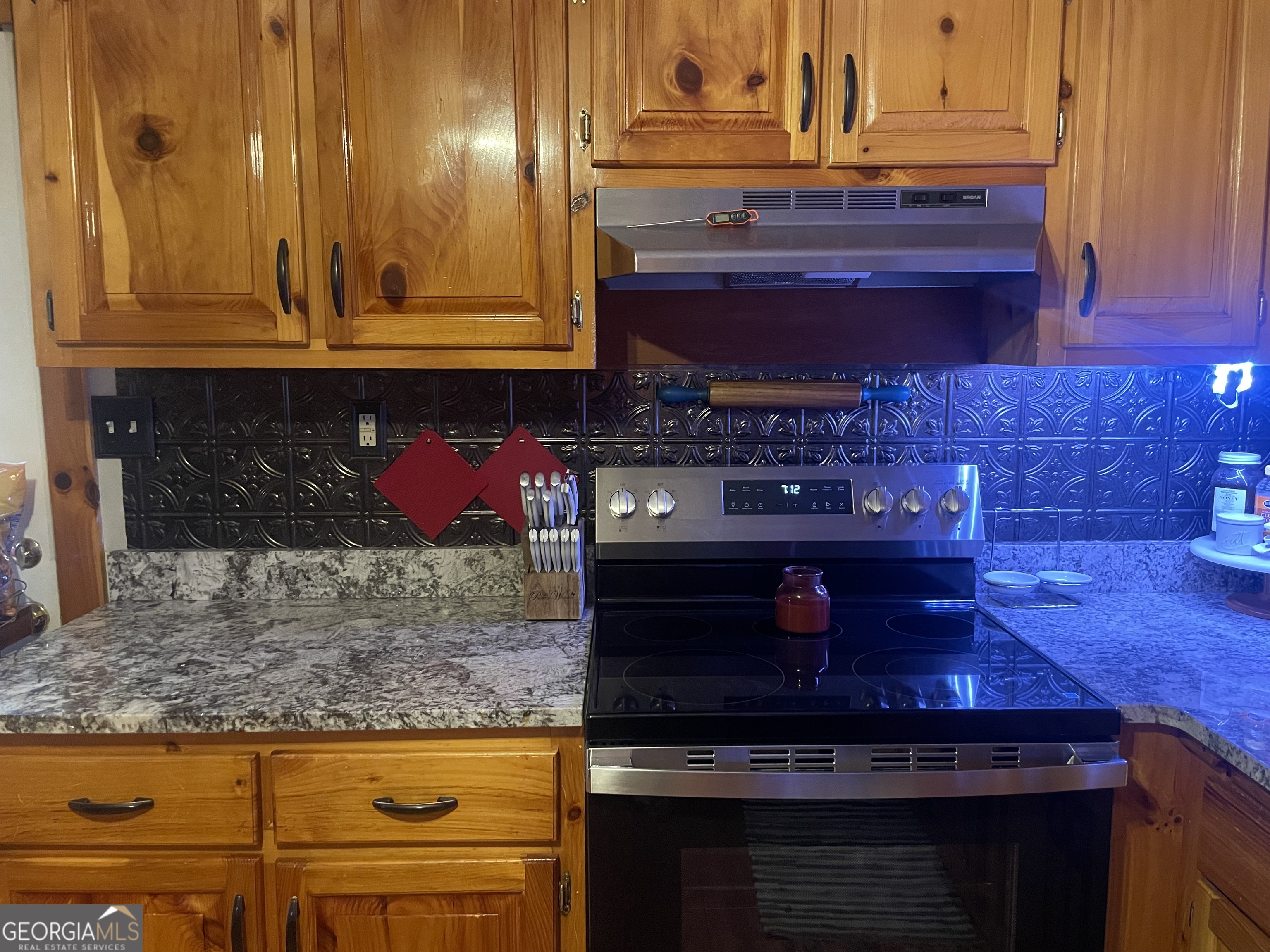 1307 Creasy Patch Road Cornelia, GA 30531 - Photo 20 of 36 a kitchen with stainless steel appliances granite countertop wooden cabinets and a counter top