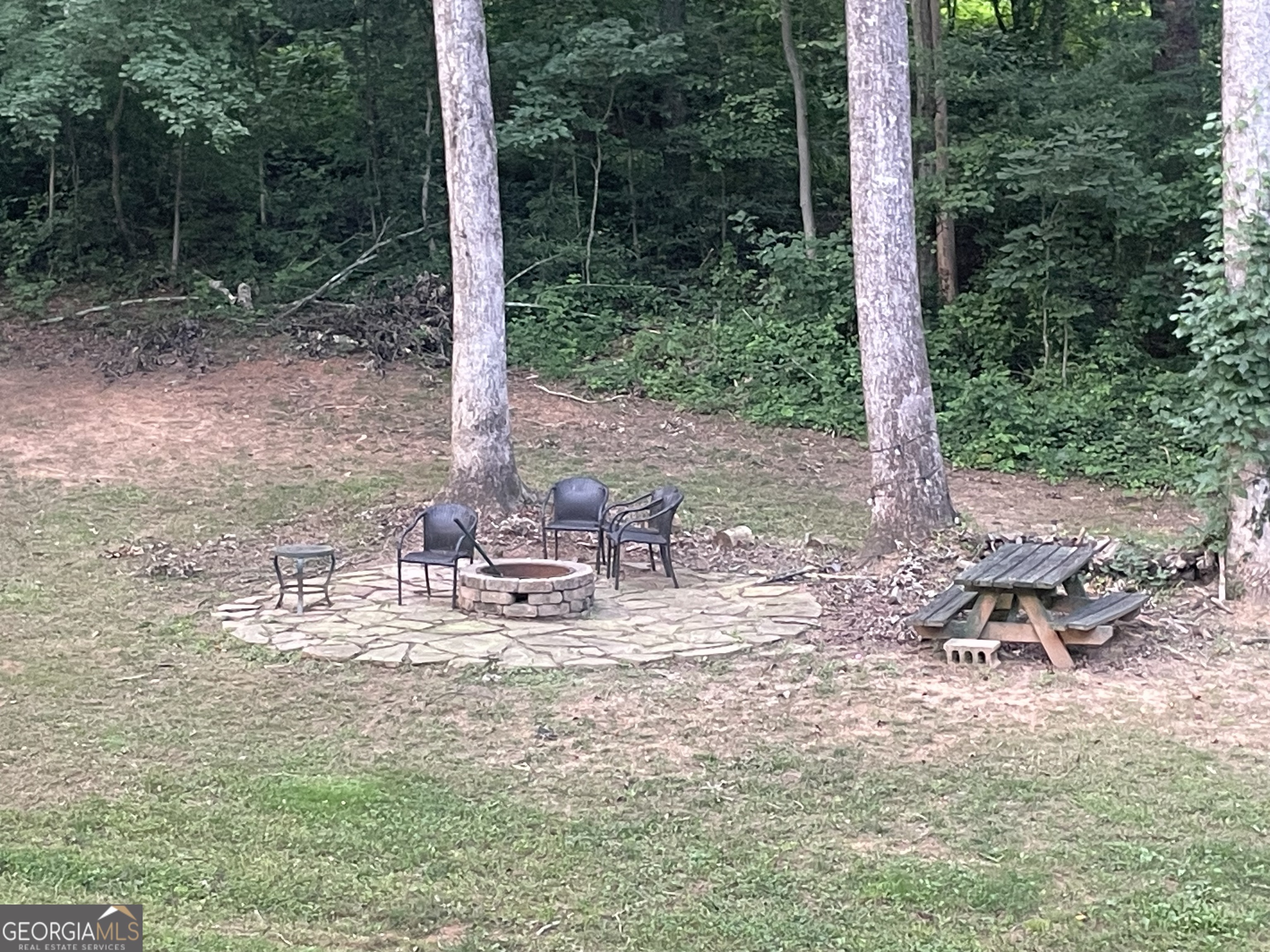 1307 Creasy Patch Road Cornelia, GA 30531 - Photo 28 of 36 a view of a chair and fire pit in the yard