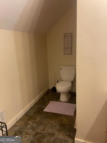 a bedroom with bed and a tv