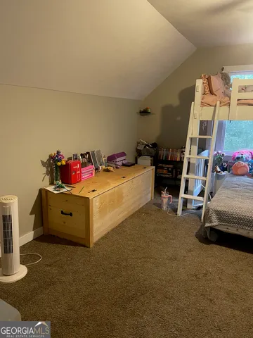 a view of a livingroom with furniture and a flat screen tv