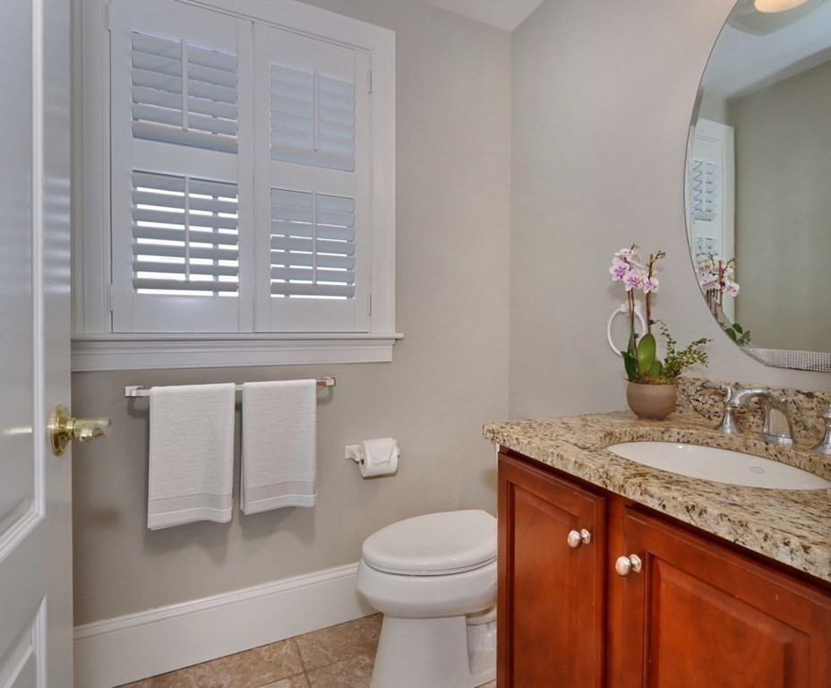 2 A Colonial Drive Arlington, MA 02474 - Photo 13 of 41 a bathroom with a granite countertop sink toilet and a mirror