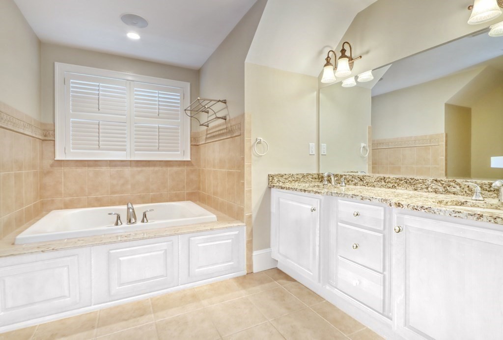 2 A Colonial Drive Arlington, MA 02474 - Photo 17 of 41 a bathroom with a granite countertop sink a large mirror and a bathtub