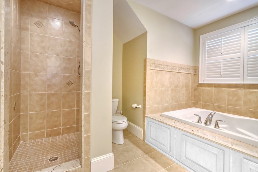 2 A Colonial Drive Arlington, MA 02474 - Photo 18 of 41 a bathroom with a granite countertop sink a toilet and shower