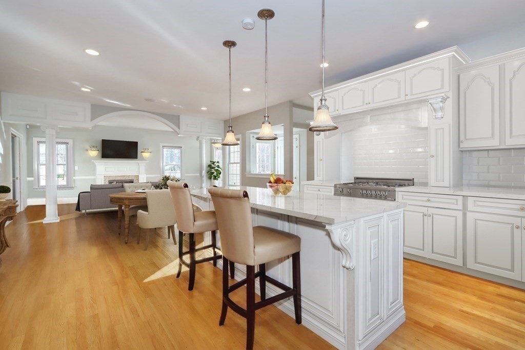 2 A Colonial Drive Arlington, MA 02474 - Photo 2 of 41 a kitchen with stainless steel appliances granite countertop table chairs sink and cabinets