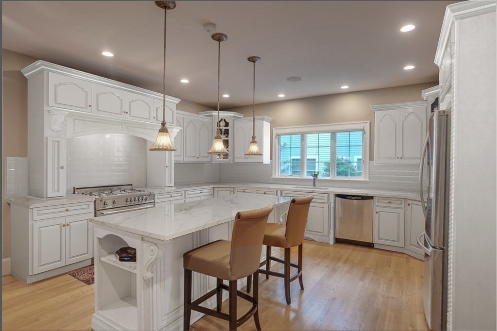 2 A Colonial Drive Arlington, MA 02474 - Photo 3 of 41 a kitchen with kitchen island granite countertop a sink cabinets and wooden floor