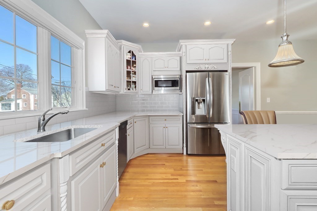 2 A Colonial Drive Arlington, MA 02474 - Photo 5 of 41 a kitchen with stainless steel appliances granite countertop a sink refrigerator and cabinets