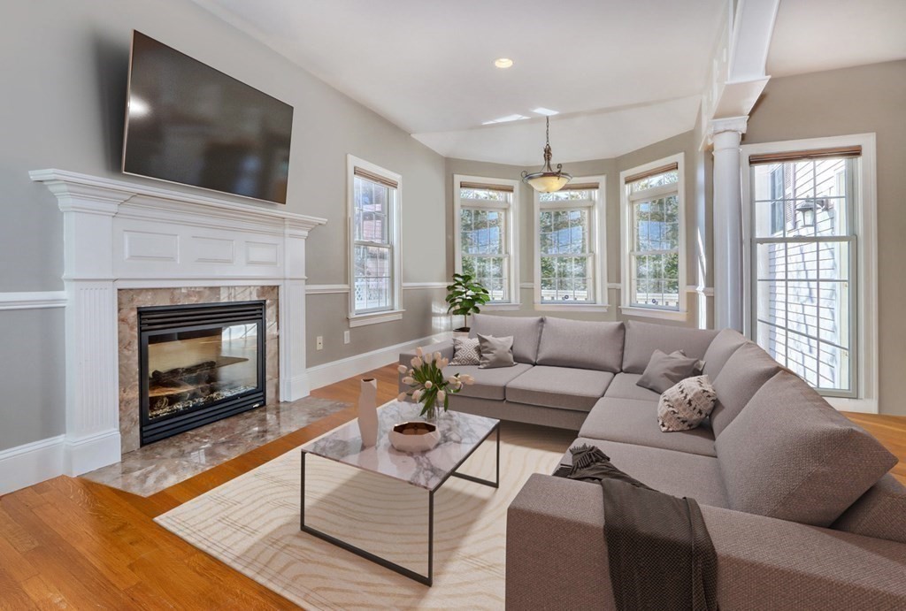 2 A Colonial Drive Arlington, MA 02474 - Photo 9 of 41 a living room with furniture a flat screen tv and a fireplace