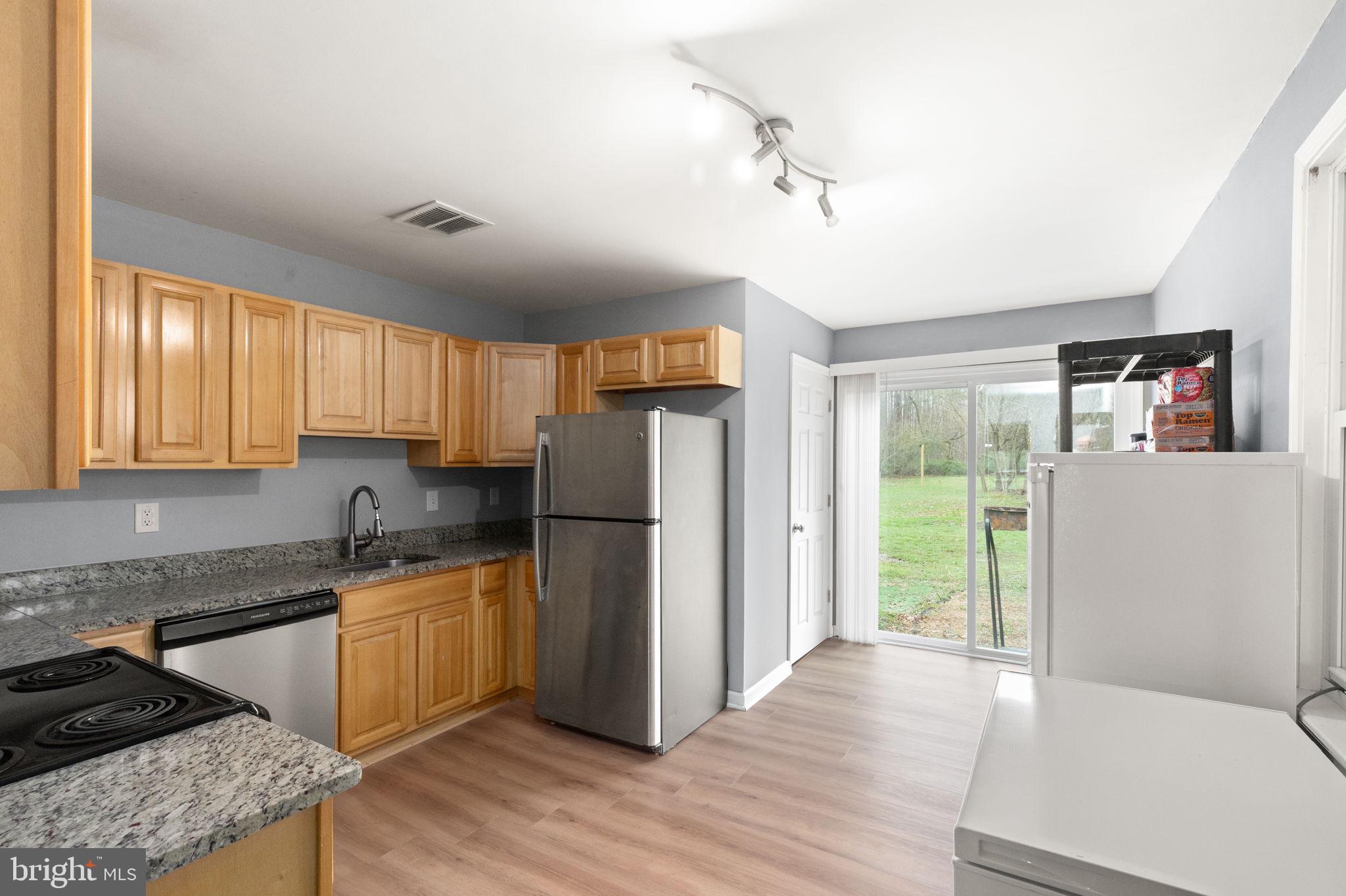 4121 Conowingo Road Darlington, MD 21034 - Photo 6 of 24 a kitchen with a refrigerator a stove cabinets and wooden floor