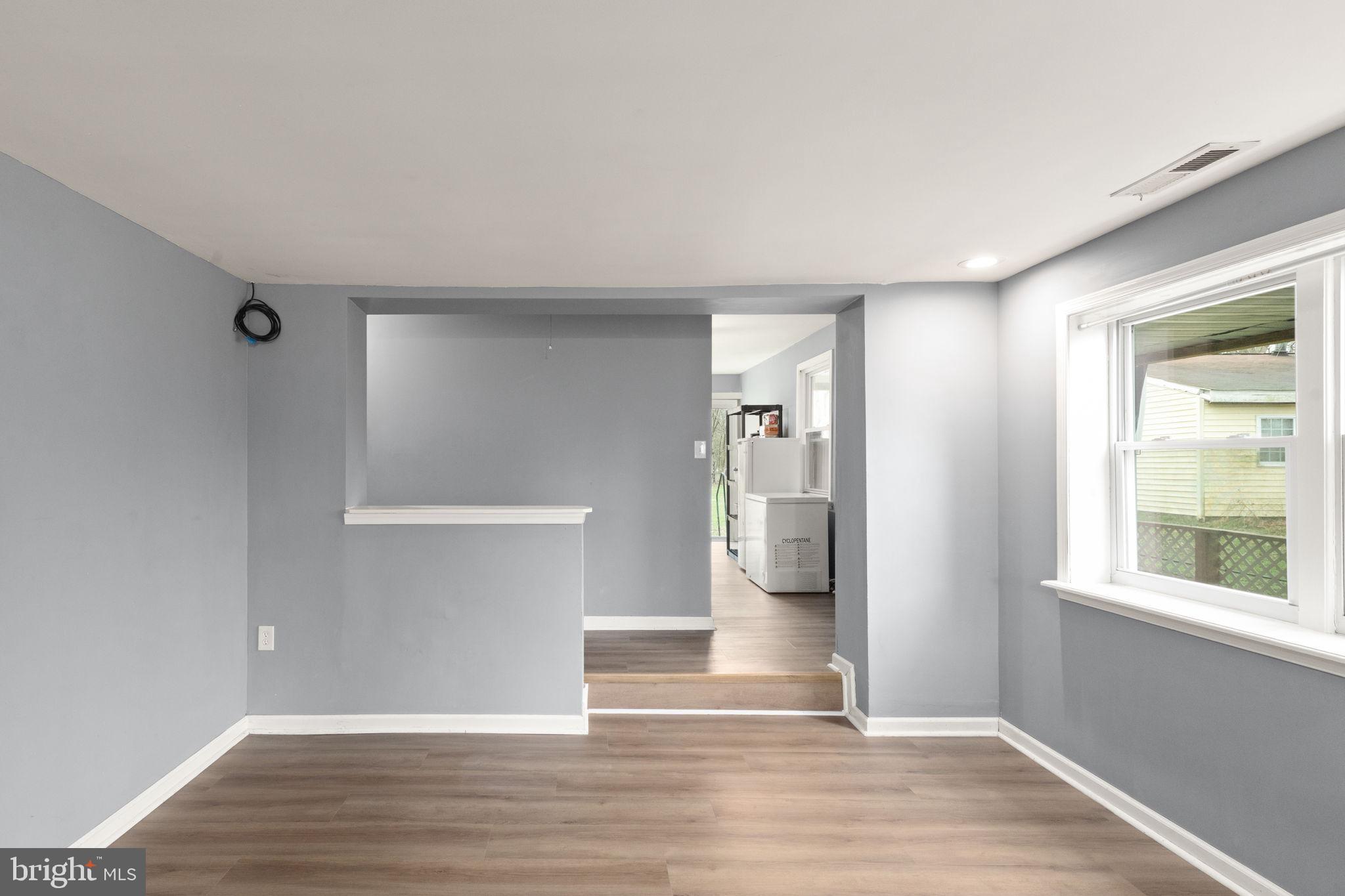 4121 Conowingo Road Darlington, MD 21034 - Photo 8 of 24 an empty room with wooden floor and windows