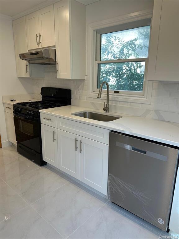 a kitchen with stainless steel appliances white cabinets and a sink