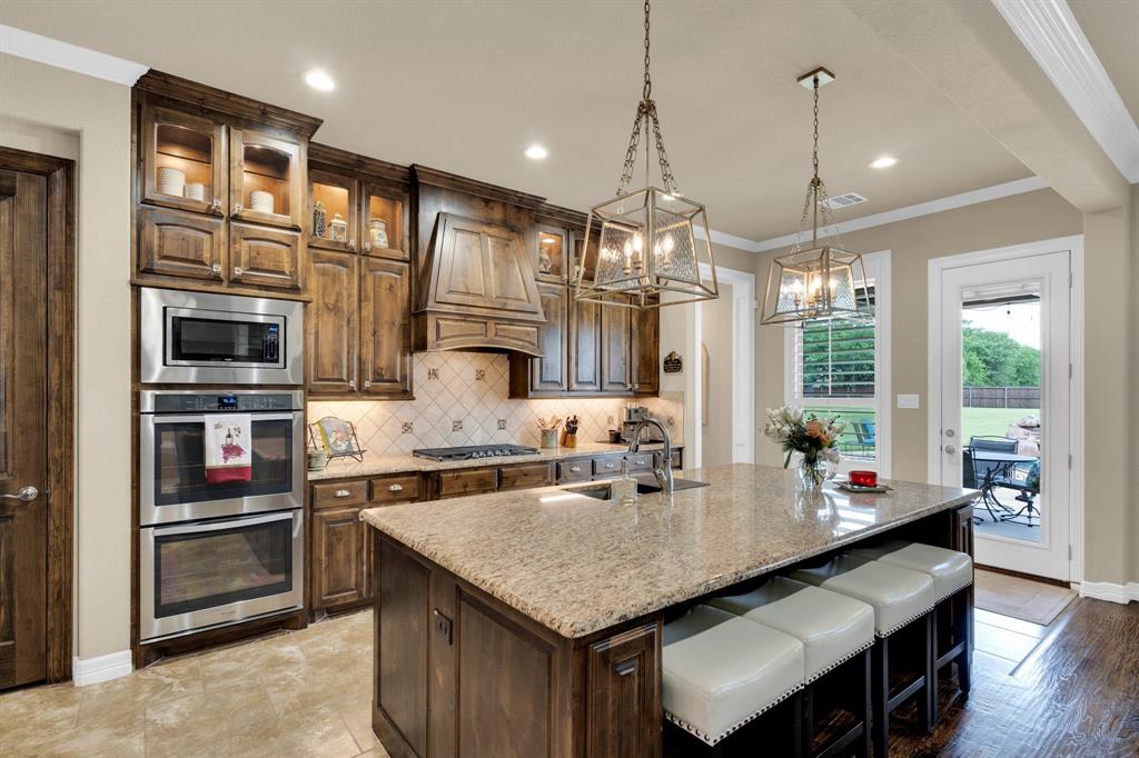 5631 Limestone Lane Midlothian, TX 76065 - Photo 13 of 40 a kitchen with stainless steel appliances granite countertop a sink a stove and refrigerator