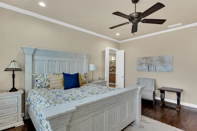 a bedroom with a large bed and a chandelier