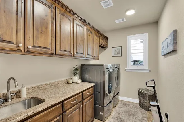 a kitchen with stainless steel appliances granite countertop a sink a stove and cabinets