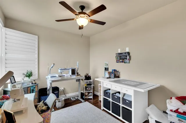 a view of a workspace with furniture and a window