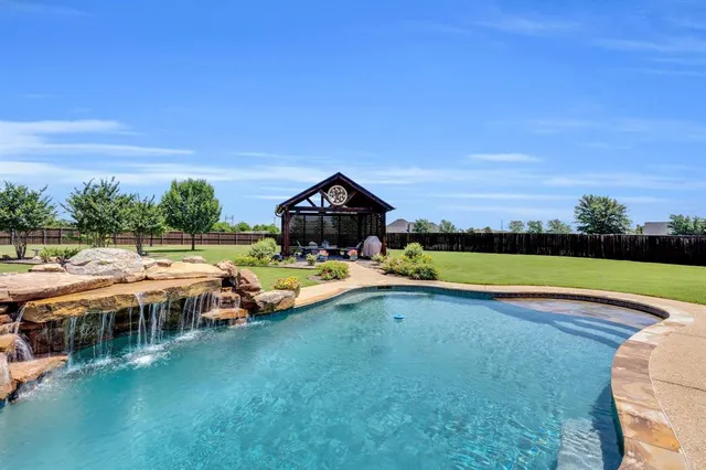 a view of swimming pool with seating area