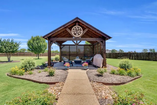 a view of a table and chairs in the garden